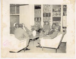 Thomas Phillips and group of men sit together in conversation