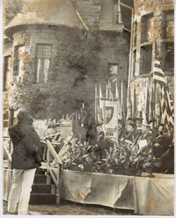 Speaker on stage during outdoor commencement ceremony