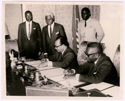 President William V. S. Tubman and Nicolas Grunitzky sign documents