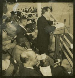 Dignitary speaks into a microphone from behind a lectern