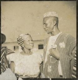 Man and woman in traditional dress look at one another