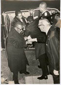 President William V. S. Tubman shakes hands with man after leaving car