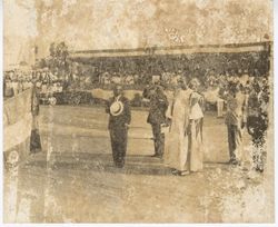 President Tubman stands with hat and hand over heart during ceremony