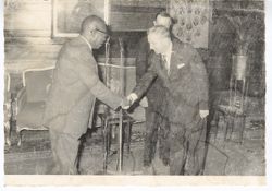President William V. S. Tubman shakes hands with dignitary at an event