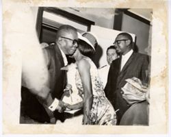 President William V. S. Tubman hugs woman with J. Rudolph Grimes in background