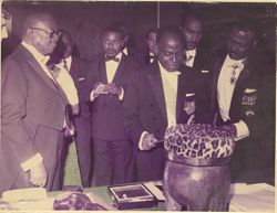 President Tubman and guests examining art objects