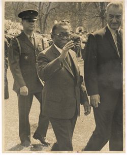 President William V. S. Tubman waves while walking with President Lyndon B. Johnson