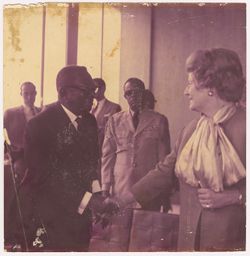 President William V. S. Tubman shakes hands with woman