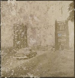 Vehicles drive down road between two large towers