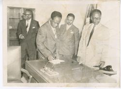 President William V. S. Tubman and officials in an office