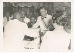 President William V. S. Tubman at a black tie event exchanging a gift with a dignitary wearing the ribbon and star of the Humane Order of African Redemption