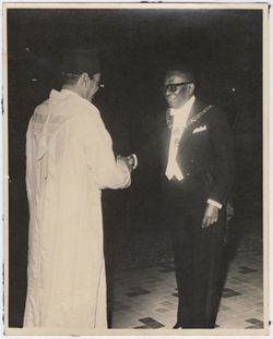 President William V. S. Tubman shakes hands with a dignitary