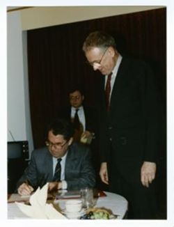 President Fischer signing book