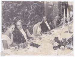 Guests seated at table at dinner party