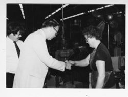 Versailles factory: shaking hands with standing woman
