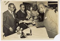 President William V. S. Tubman receives documents from guest