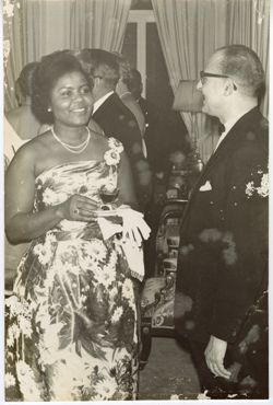 Assistant CEO of Swedish LAMCO Syndicate chats with woman during a formal reception