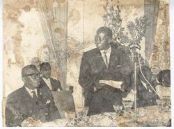 Unidentified man addressing President Tubman during speech
