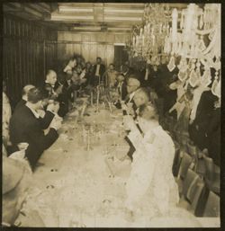 Guests stand and raise glasses to a toast during a formal reception