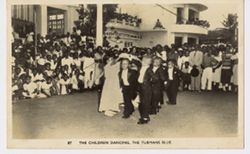 Children dancing as crowd watches