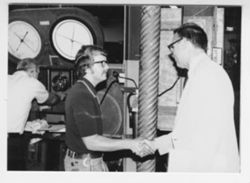 Versailles factory: Hamilton shaking hands with a man
