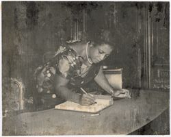 Mrs. Antoinette Tubman signs book