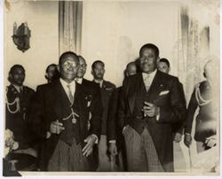 President William V. S. Tubman stands with officials in formal attire at a reception