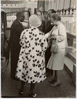 President William V. S. Tubman greets and shakes hands with small group outside automobile