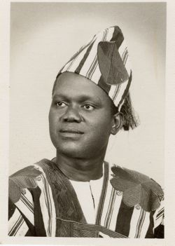 Portrait of young man in traditional garb and headgear