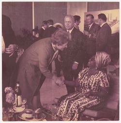 Woman shakes hands with the First Lady of Liberia