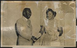 President Tubman shakes hands with a dignitary