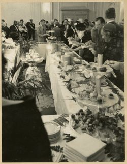 Guests at reception stand around buffet table