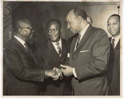 President William V. S. Tubman shakes hands with man in receiving line