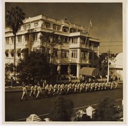 Liberian military unit parades past the Executive Mansion on Ashmun Street