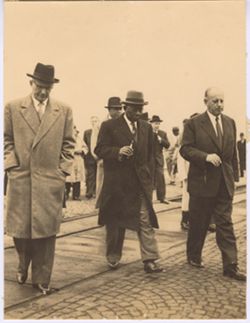 President Tubman walking with men in business attire
