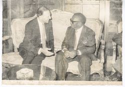 President William V. S. Tubman chats with official in a formal sitting area