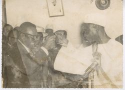 President William V. S. Tubman toasts with man in front of an ELWA microphone