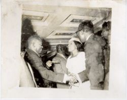 President William V. S. Tubman greets a guest as a young woman talks