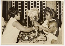 Mrs. Tubman receives flowers from guest, President William V. S. Tubman by her side