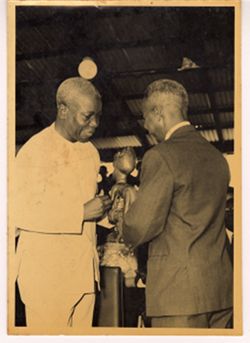 Small statue is given from one man to another