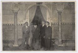 President Tubman stands with dignitaries in a ornately tiled room