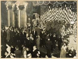 Guests at reception with several American flags in background