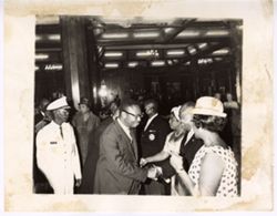 Man shakes hand with group in receiving line