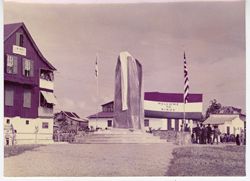 Different angle of covered monument before "Welcom to Sinoe" banner