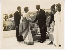 Greeting between Ambassador Charles T. O. King and other dignitary