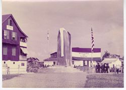Covered monument before Welcome to Sinoe banner