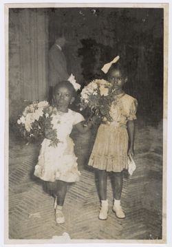 President Tubman's daughter, Coocoo, and friend Banke King hold bouquets of flowers