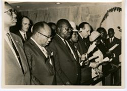 President Tubman and other guests sing during a memorial service