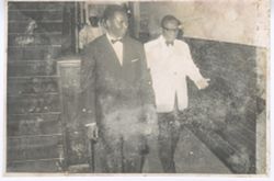 President William V. S. Tubman and man walk down hall