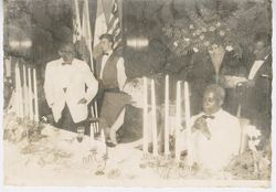 President William V. S. Tubman stands and overlooks guests at head dinner table during formal event